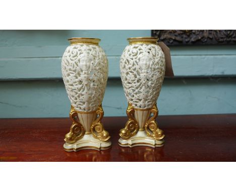 Pair of pierced white ground Royal Worcester urn shaped specimen vases in similar style each on gilded triangular base