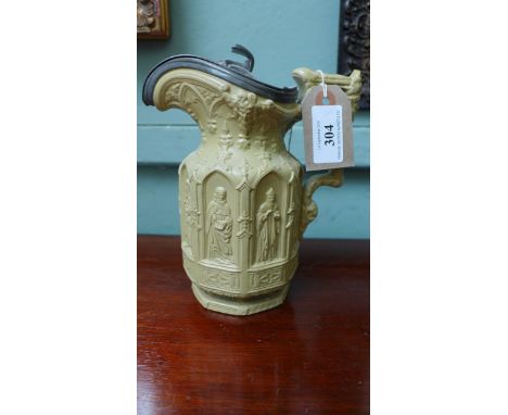 Mid 19th century light brown jug with apostles arched raised decoration, pewter lid
