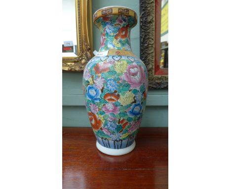 Multi coloured floral design urn shaped mantel piece vase (approx 11" high) chip to rim and a clouded light blue glass mantel