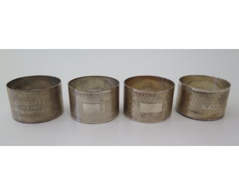 A Set of Four George V Silver Napkin Rings with engine turned decoration, AM Co., 149 g