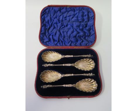 A Victorian Presentation Cased Set of Four Apostle Top Serving Spoons with scalloped bowls, London 1895, William Hutton & Son