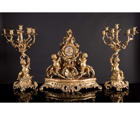 Important gilt metal Napoleon III figural mantel clock and two candelabra. Clock is stamped 'Popon à Paris', on a carved and 
