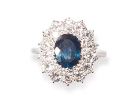 Sapphire and diamond ring. White gold ring with oval sapphire, weighing approx 1.50 carats, within a sorround of diamonds, si