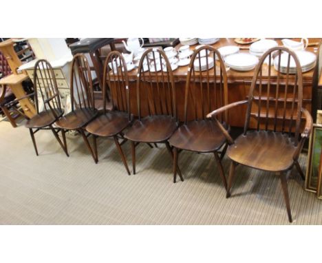 A set of six blue label Ercol dining chairs, including two carvers in dark wood Condition: structurally sound, wear to one of