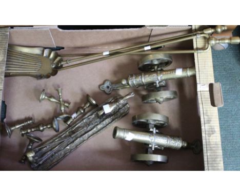 A collection of brass wares, includes a pair of canon, fire tools, candlesticks, and a brass plough team