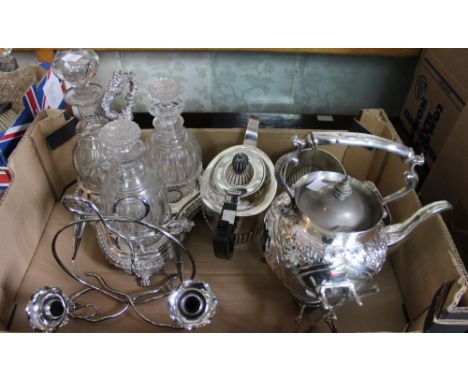 A quantity of silver plated wares, includes a three piece tea set, spirit kettle on stand, epergne and a three bottle decante