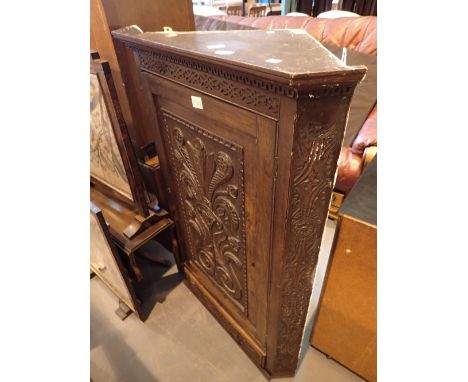 Antique oak corner wall cupboard with carved panel doors