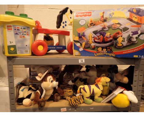 Shelf of Fisher Price toys games and soft toys