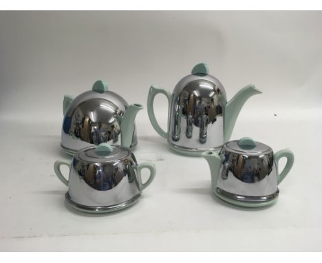 A four piece Art Deco tea and coffee set with a ceramic base and chromed lid/cover. Damage to the sugar pot