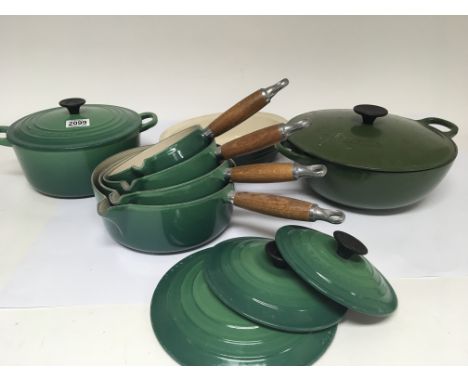 A set of Le Creuset green enamel saucepans and Casarol dishes.Comprising four graduating saucepans three lids, two round cook