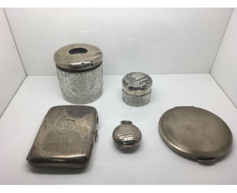 A collection of silver items to include a cigarette case, a sovereign case, a compact and a hair tidy bottle