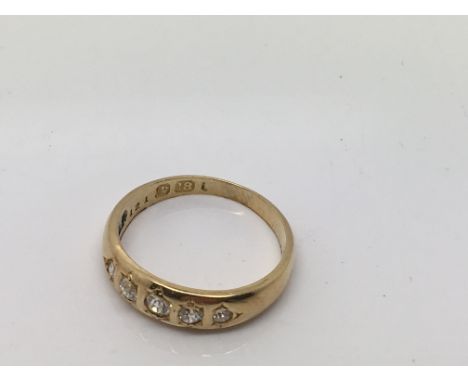 An 18ct gold ring with five small diamonds.Approx size K/J