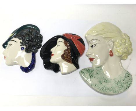 Three Art Deco style ceramic wall masks.