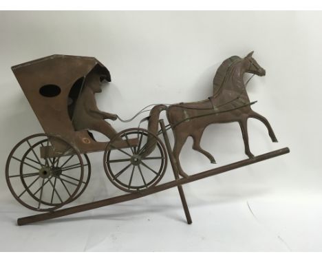 A copper weather vane ornament of a four wheeled horse drawn carriage with the driver, possibly American