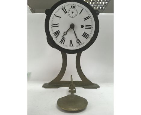 A unusual ships style brass clock the enamel dial with Roman numerals 30 cm