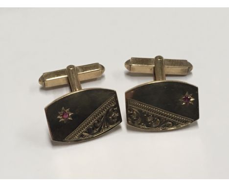 A pair of 9ct Gold cufflinks set with small rubies. Weight 8g.