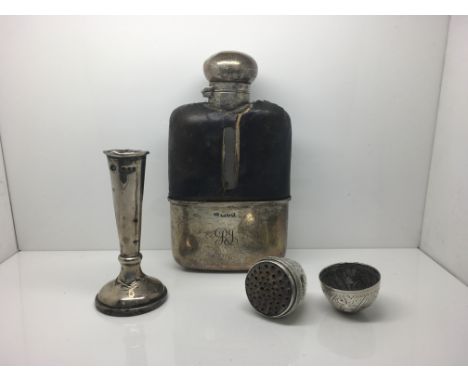 A collection of items to include a silver hip flask, a silver posy vase and a nutmeg grinder