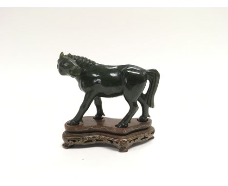 A 20th century green jade carving of a horse on an inlaid wooden base