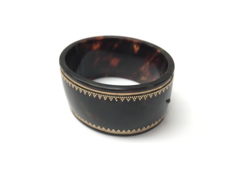 A Victorian tortoiseshell bangle.