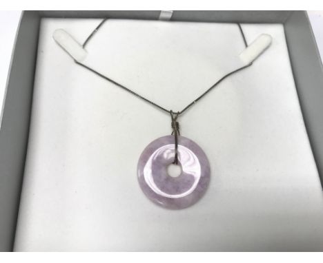 A jade lavender pendant with silver chain.