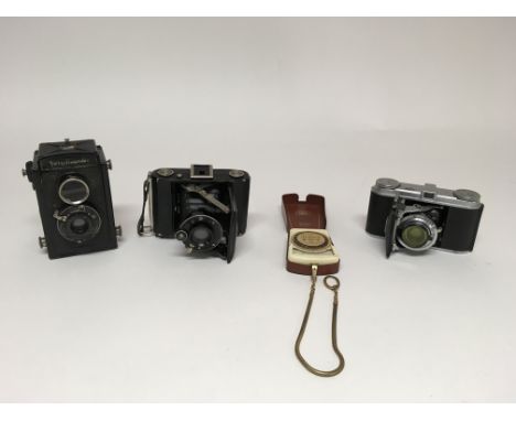 A small collection of cameras to include a Zeiss Ikon Ikonta camera, a Voigtlander Vito, a Voigtlander Brilliant and a Zeiss 
