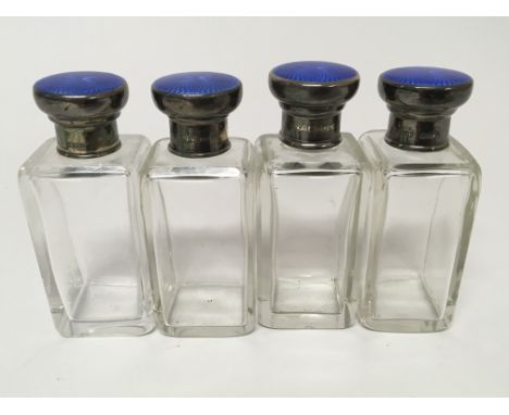 A set of Four silver and enamel topped scent bottles. (4)