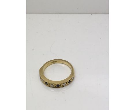 An 18ct gold ring set with chip diamonds and sapphires.Approx size J/k