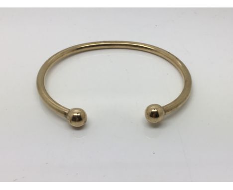 An unmarked gold torque bangle tested as 9ct