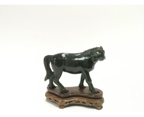 Another 20th century green jade carving of a horse on an inlaid wooden base