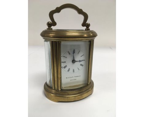 A small Matthew Norman brass carriage clock, approx height 8.5cm.