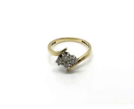 An18 carat yellow gold ring set with a cluster of four diamonds. Ring size K.