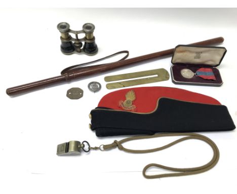 A collection of miliatary items including a cap, medal, swagger stick, binoculars, whistle etc.