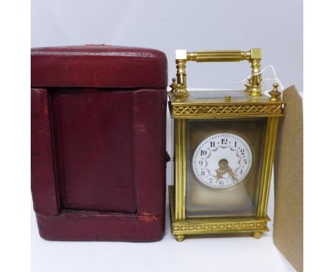 A late 19th century French brass repeating carriage clock, the convex enamel dial with Arabic numerals, floral decoration to 