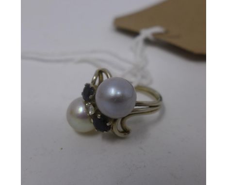A ladies white metal, pearl and sapphire dress ring 