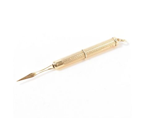 A hallmarked 9ct gold mechanical toothpick. The toothpick having engine turned decoration with round bale to top. Hallmarked 
