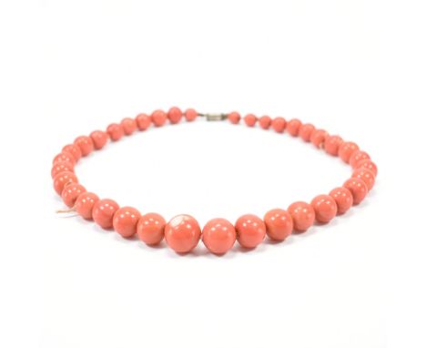 A vintage ceramic beaded necklace. The necklace having graduating round beads with a screw clasp. Largest bead measures 1.6cm