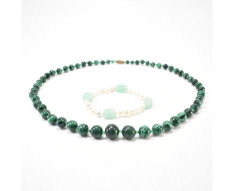 A vintage malachite beaded necklace together with a cultured pearl and jade bracelet. The malachite necklace having round gra