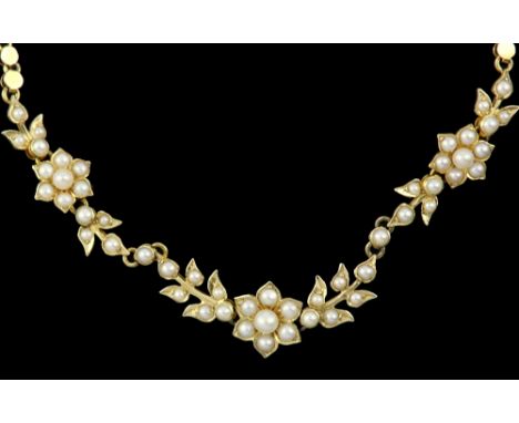 Edwardian seed pearl floral necklace, integrated fancy link chain, box clasp, testing as 18 ct, measuring approximately 39cm 