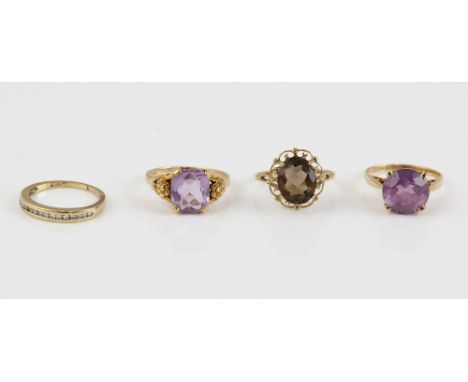 Four gem set rings, one diamond channel set half eternity ring, size H, two amethyst dress rings, size I and K, with a Smokey