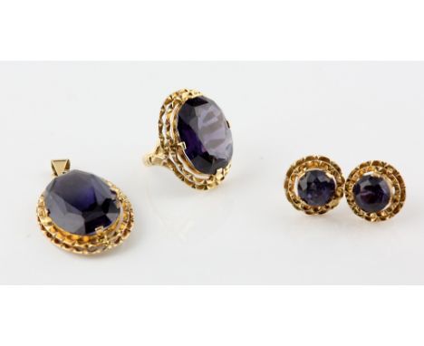 Synthetic colour change sapphire suite of jewellery oval cut stone ring, similar pendant and a pair of round cut earrings, al