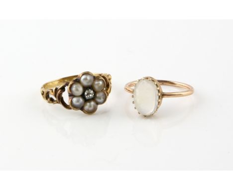 Early 19th C pearl and diamond ring, central old cut diamond, set within a border of six white round half pearls, measuring a