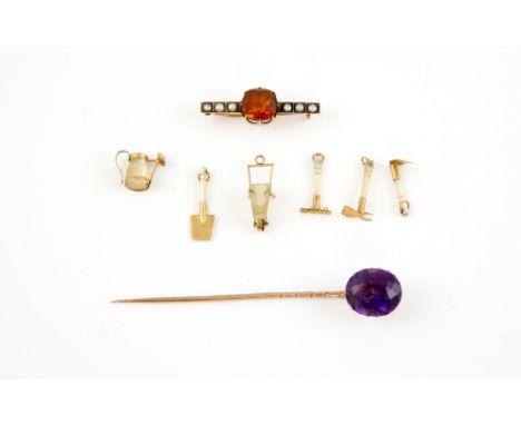 Victorian amethyst stick pin, orange quartz and seed pearl brooch, both in 9 ct, and six mother of pearl gardening tool charm