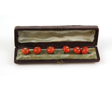 Six Victorian coral buttons, coral measuring approximately 10mm diameter, fittings testing as 9 ct, in fitted box .     CONDI