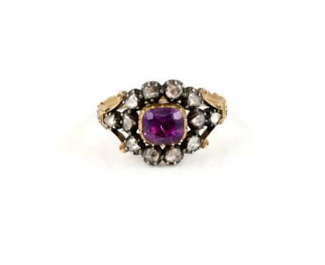 Georgian memorial ring, central foil backed amethyst, set in a frame of  rose cut diamonds, scrolling black enamel band, insc