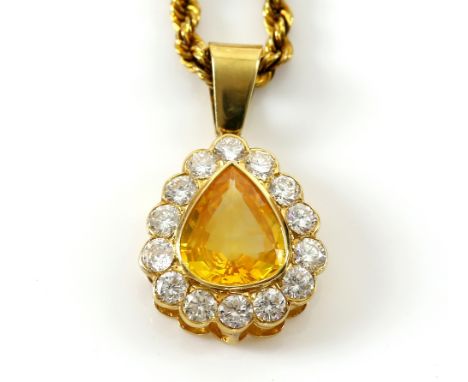 Yellow sapphire cluster pendant, central pear cut sapphires, estimated weight 3.74 carats, set within a border of fourteen tr