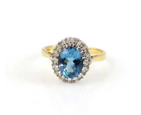 Blue topaz and diamond cluster ring, central oval cut blue topaz, estimated weight 2.12 carats, set in a frame of Swiss cut d
