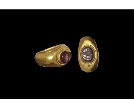 Roman Gold Ring with Poppy Intaglio 1st-2nd century AD. A D-section hoop with flanged edges, expanding shoulders, plaque with