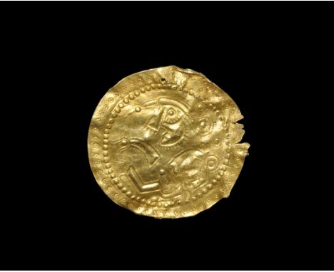 Scandinavian Pre-Viking Gold Figural Bracteate 6th century AD. A broad repoussé bracteate of Type C with outer band of punche