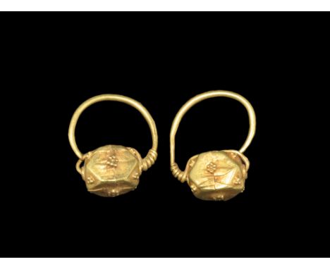 Late Roman Gold Polyhedral Earrings 5th century AD. A matched pair of earrings, each a substantial wire hoop with coil to one