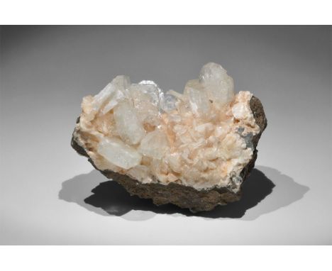 Geological Heulandite with Apophyllite Mineral Specimen A group of colourless, tabular apophyllite crystals rest on a bed of 